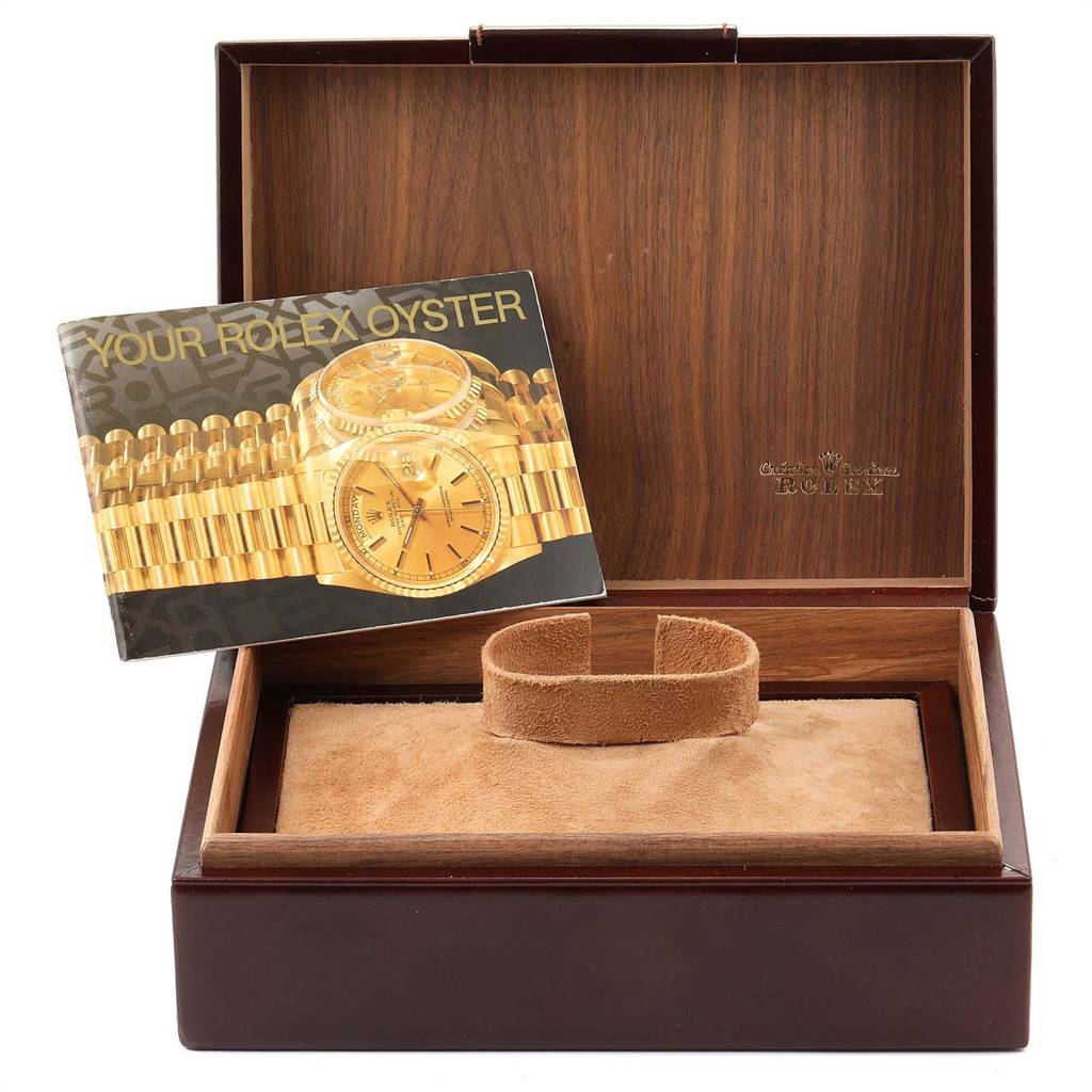 The image shows a Rolex President 18038 Men
s Yellow Gold Silver Dial 18038 Men
s Yellow Gold Silver Dial watch box with an instruction booklet and a watch cushion inside.