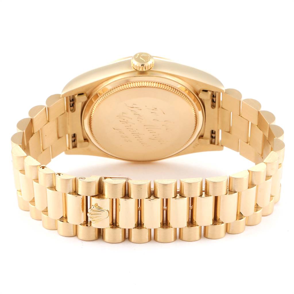 The image shows the back and bracelet of a Rolex President 18038 Men
s Yellow Gold Silver Dial 18038 Men
s Yellow Gold Silver Dial model watch at an angle displaying the case back and crown.