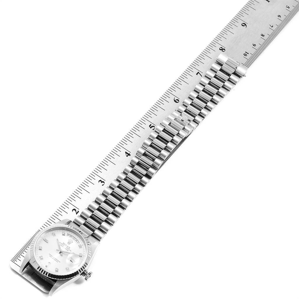 The image displays a Rolex President 18239 Men's White Gold Silver Dial 18239 Men's White Gold Silver Dial model watch, positioned at an angle revealing the bracelet and part of the dial alongside a ruler.
