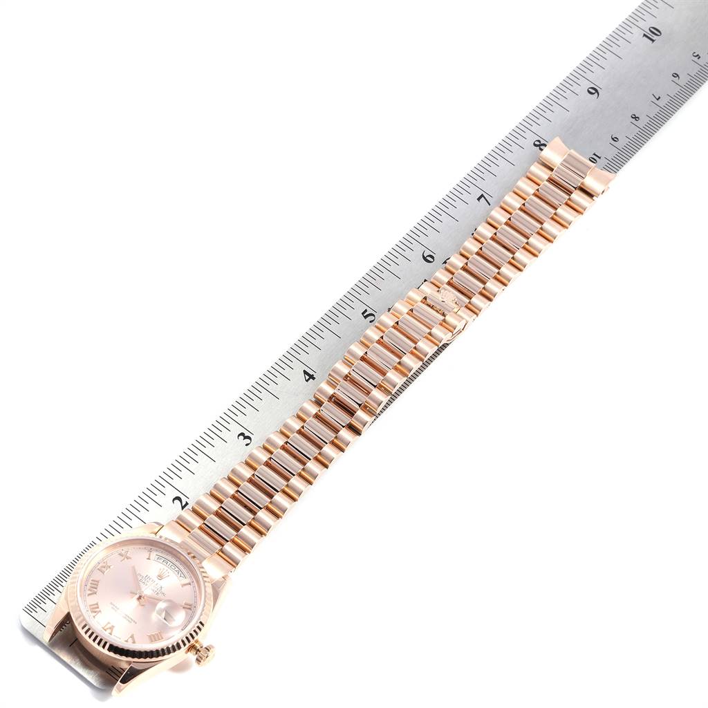 The image shows a Rolex President 118235 Men's Rose Gold Champagne Dial 118235 Men's Rose Gold Champagne Dial model watch placed beside a ruler, highlighting its length and bracelet.