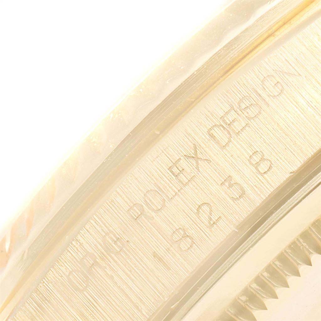 This close-up image shows the outer edge with engravings of a Rolex President 18238 Men
s Yellow Gold Black Dial 18238 Men
s Yellow Gold Black Dial model wristwatch.