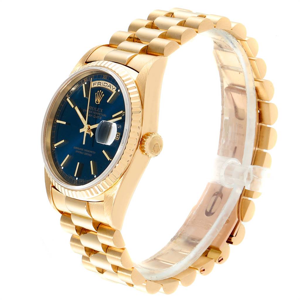 The image shows a side angle of a Rolex President 18238 Men
s Yellow Gold Blue Dial 18238 Men
s Yellow Gold Blue Dial model watch, highlighting the gold bracelet, blue dial, and crown.