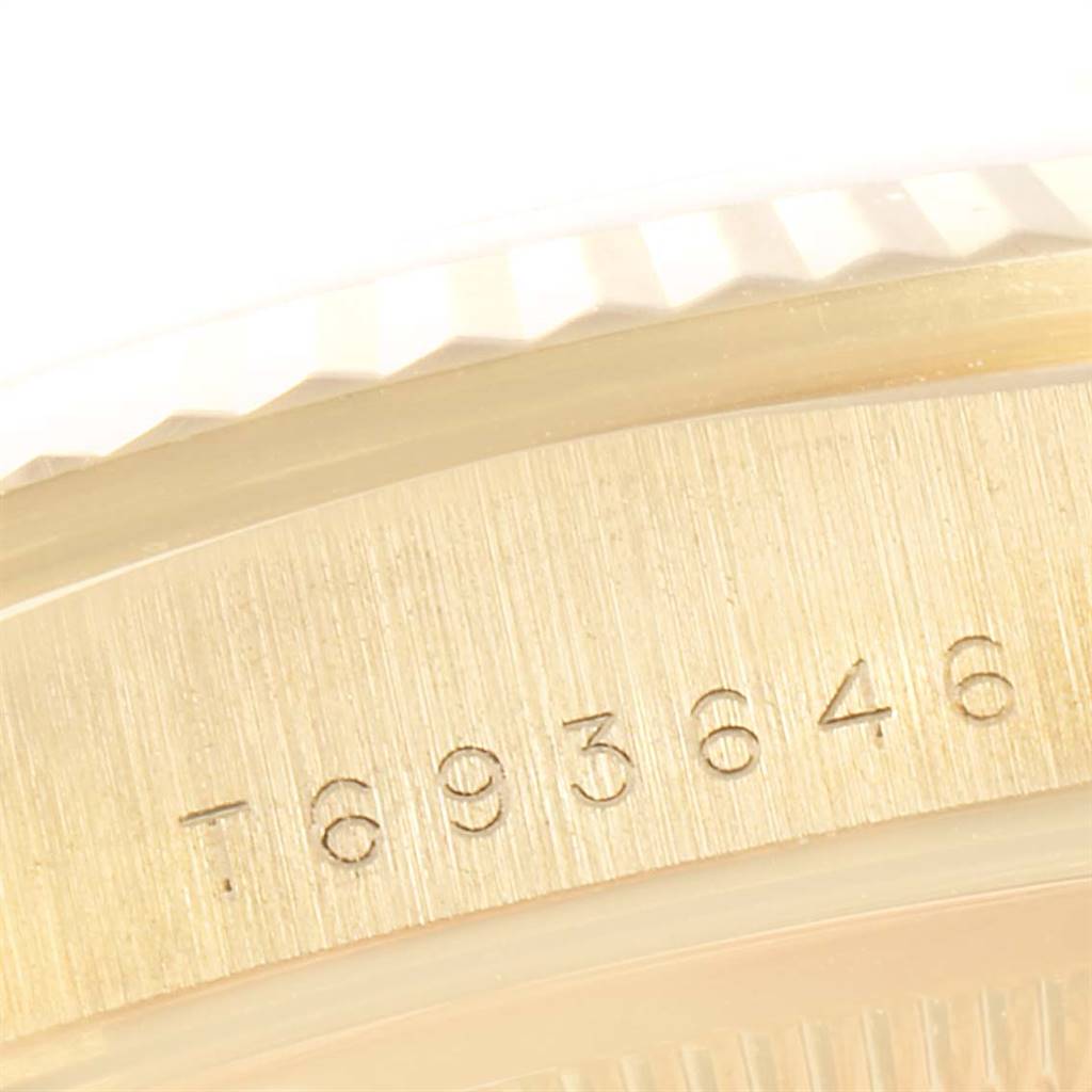 This image shows a close-up of the serial number engraved on the side of a Rolex President 18238 Men
s Yellow Gold Blue Dial 18238 Men
s Yellow Gold Blue Dial model watch.
