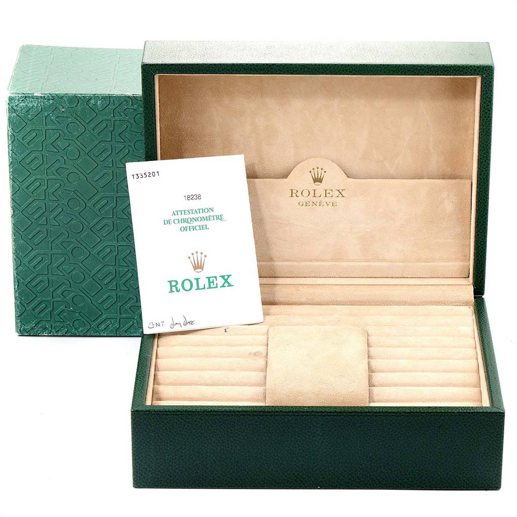 This image shows an open green Rolex box for the President model, including official documentation inside.