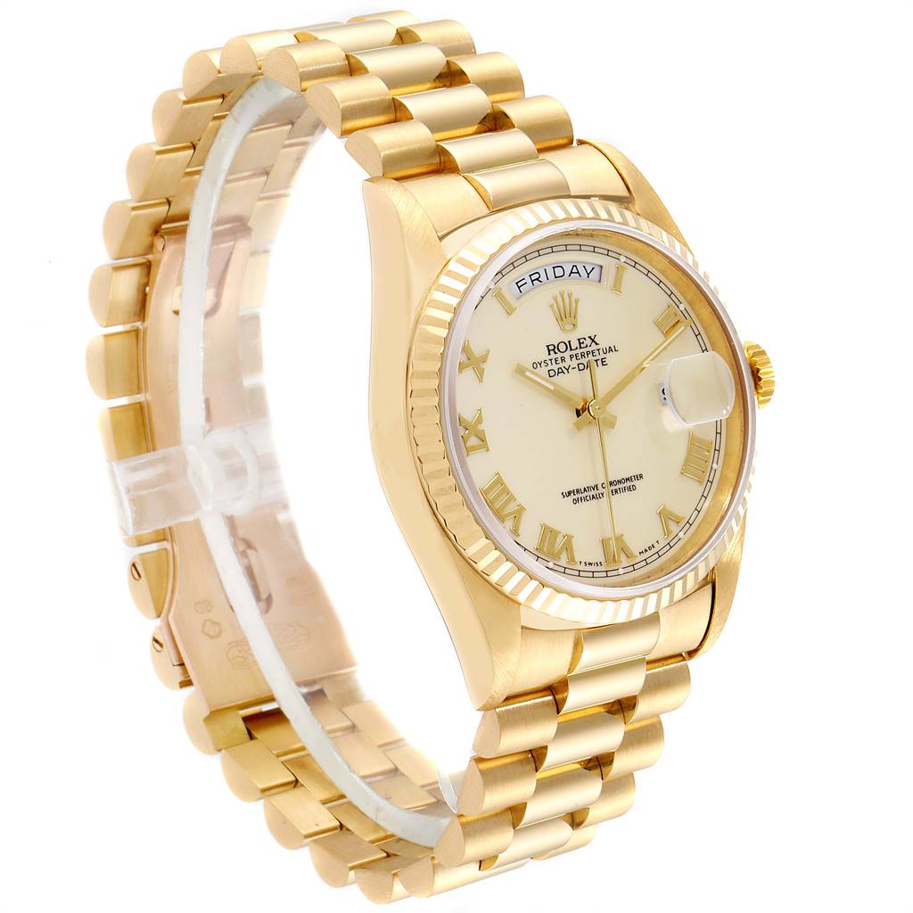 The image shows a tilted side view of a Rolex President 18238 Men
s Yellow Gold Beige Dial 18238 Men
s Yellow Gold Beige Dial model watch, displaying its gold bracelet, fluted bezel, and dial with Roman numerals.