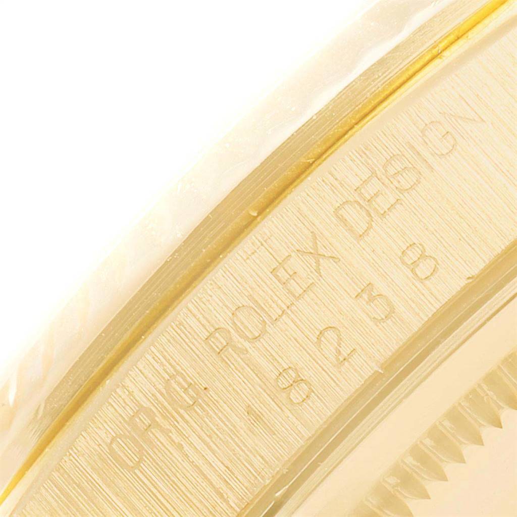 This close-up image shows the embossed serial number and part of the bezel of a Rolex President 18238 Men
s Yellow Gold Beige Dial 18238 Men
s Yellow Gold Beige Dial model watch.