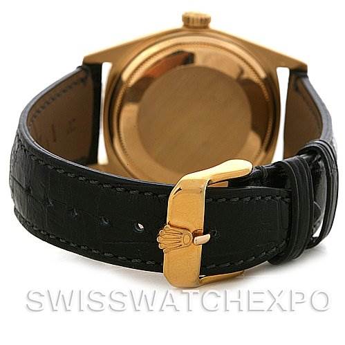 The image shows the back and clasp of a Rolex President 18038 Men's Yellow Gold White Dial 18038 Men's Yellow Gold White Dial model watch, highlighting its gold case and black leather strap.