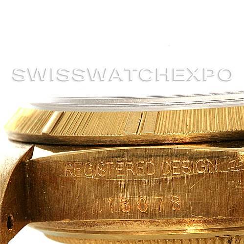 The image shows a close-up of the side of the Rolex President 18038 Men
s Yellow Gold Champagne Dial 18038 Men
s Yellow Gold Champagne Dial watch case, highlighting the fluted bezel and engraved details.