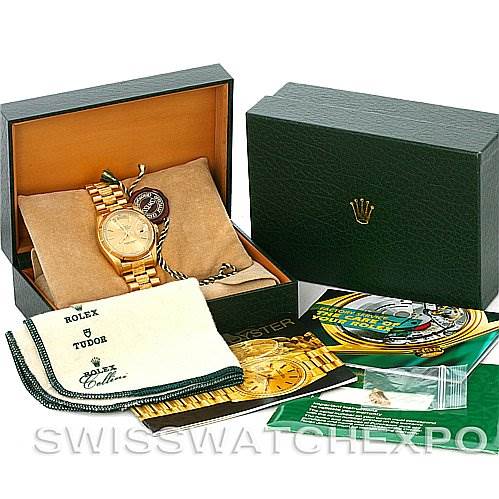 The image shows a Rolex President 18038 Men
s Yellow Gold Champagne Dial 18038 Men
s Yellow Gold Champagne Dial watch with its box, cleaning cloth, manuals, and tags, photographed from a high-angle view.