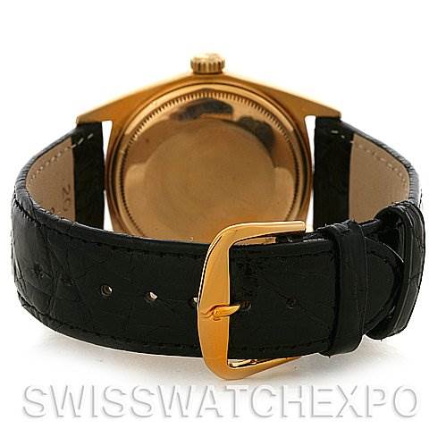 The image shows the back of a Rolex President 1803 Men
s Yellow Gold Black Dial 1803 Men
s Yellow Gold Black Dial model watch, focusing on the leather strap and gold buckle.