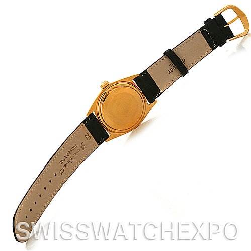 The image shows the back of a Rolex President 1803 Men
s Yellow Gold Black Dial 1803 Men
s Yellow Gold Black Dial model watch with a leather strap, positioned at an angled view.