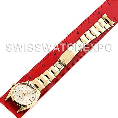 The pictured Rolex President 1500 Men's Yellow Gold Silver Dial 1500 Men's Yellow Gold Silver Dial model watch shows the entire watch laid flat next to a red ruler, showcasing the face and bracelet.