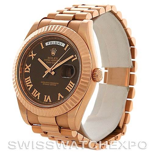 The image shows a Rolex President 218235RRP Men's Rose Gold Pink Dial 218235RRP Men's Rose Gold Pink Dial model watch featuring a rose gold band, fluted bezel, and dark dial with Roman numerals.