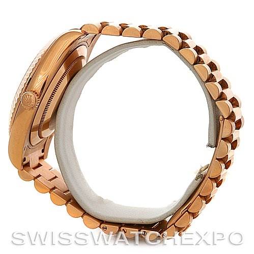 The image shows a side view of a Rolex President 218235RRP Men's Rose Gold Pink Dial 218235RRP Men's Rose Gold Pink Dial model watch, highlighting the bracelet and side of the case.