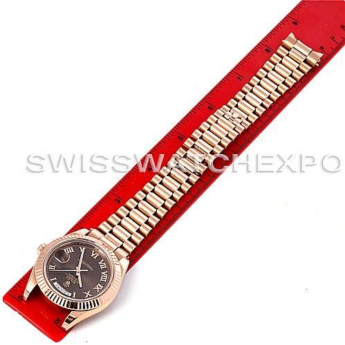 The image shows a Rolex President 218235RRP Men's Rose Gold Pink Dial 218235RRP Men's Rose Gold Pink Dial model watch laid flat next to a red ruler, displaying the face and entire bracelet.