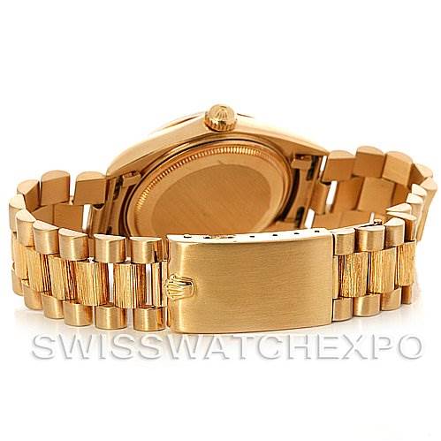 The image shows the backside of a Rolex President 1807 Men's Yellow Gold Champagne Dial 1807 Men's Yellow Gold Champagne Dial model watch, focusing on the case back and the President bracelet.