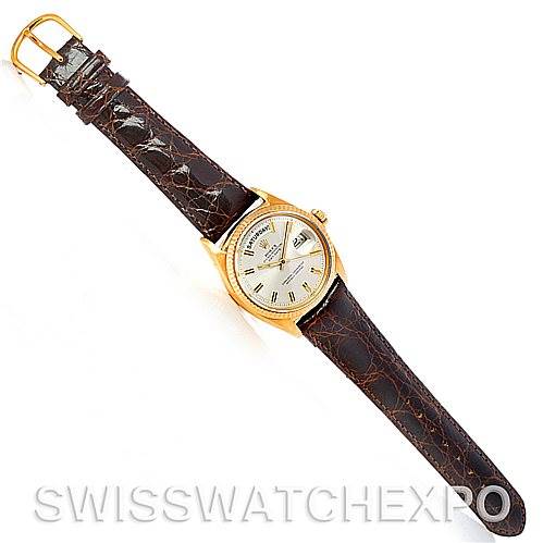 The image shows a top-down view of a Rolex President 1803 Men's Yellow Gold Silver Dial 1803 Men's Yellow Gold Silver Dial model watch with a brown leather strap and gold case.