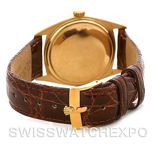 The image shows the back view of a Rolex President 1803 Men's Yellow Gold Champagne Dial 1803 Men's Yellow Gold Champagne Dial model watch, focusing on its case, leather strap, and gold buckle.