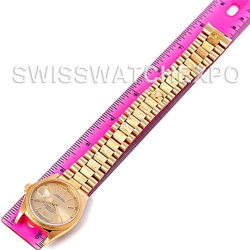 The image shows a Rolex President 18078 Men's Yellow Gold Champagne Dial 18078 Men's Yellow Gold Champagne Dial model watch lying flat against a ruler, displaying its entire bracelet and bezel.