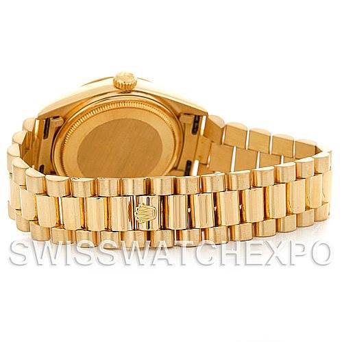 The Rolex President 18038 Men's Yellow Gold White Dial 18038 Men's Yellow Gold White Dial model is shown from the back, highlighting the case back and the gold bracelet with a signature clasp.