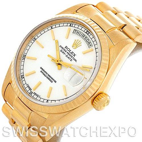 The image shows a close-up of a Rolex President 18038 Men's Yellow Gold White Dial 18038 Men's Yellow Gold White Dial model watch, highlighting its gold case, bracelet, and white dial with a day-date display.