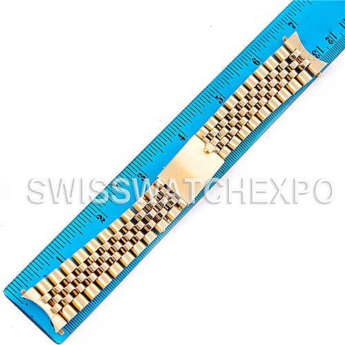The image shows a gold bracelet for the Rolex President   model, measured against a blue ruler.