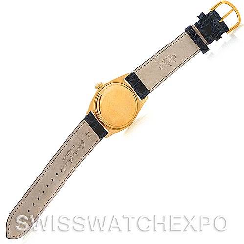 The image shows the back view of a Rolex President 1803 Men's Yellow Gold Blue Dial 1803 Men's Yellow Gold Blue Dial model watch with an open leather strap and gold case.