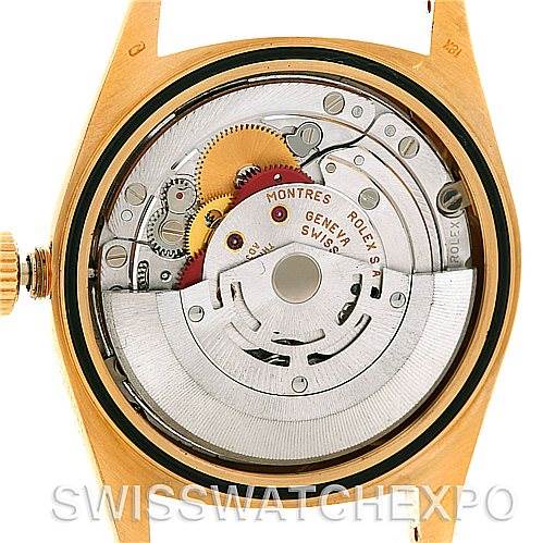 This image shows the back view of an open Rolex President 18238 Men's Yellow Gold Grey Dial 18238 Men's Yellow Gold Grey Dial watch, revealing its intricate inner mechanical movements.