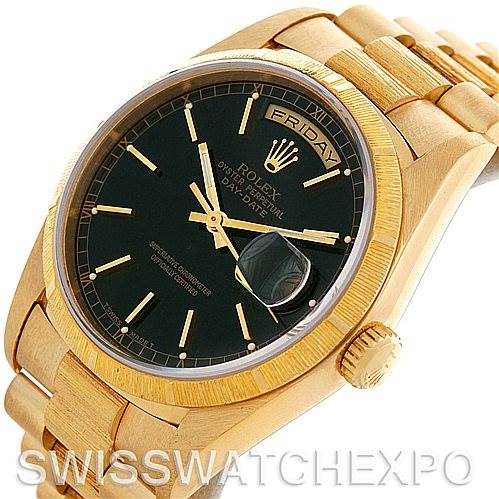 This image shows a Rolex President 18248 Men's Yellow Gold Black Dial 18248 Men's Yellow Gold Black Dial watch, displaying its black dial, day-date feature, and gold casing at an angled perspective.