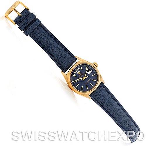 The image shows a Rolex President 1803 Men's Yellow Gold Blue Dial 1803 Men's Yellow Gold Blue Dial model watch from a top-down angle, featuring a blue leather strap and a gold case.