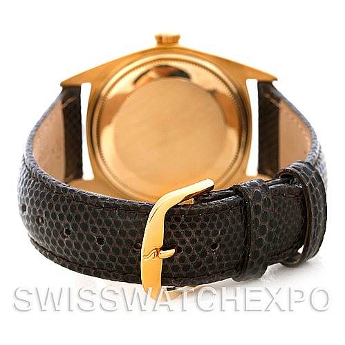 The image shows the back of a Rolex President 1803 Men's Yellow Gold Champagne Dial 1803 Men's Yellow Gold Champagne Dial model watch, showcasing its leather strap and gold buckle.