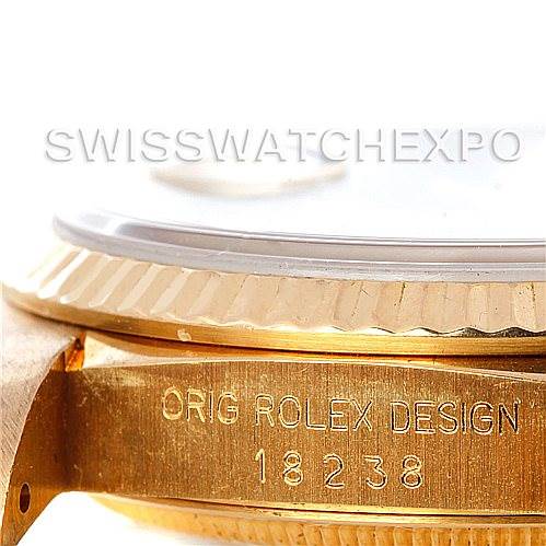 This close-up angled shot of a Rolex President 18238 Men
s Yellow Gold Champagne Dial 18238 Men
s Yellow Gold Champagne Dial watch showcases the side view with focus on the bezel and "Orig Rolex Design 18238" inscribed.