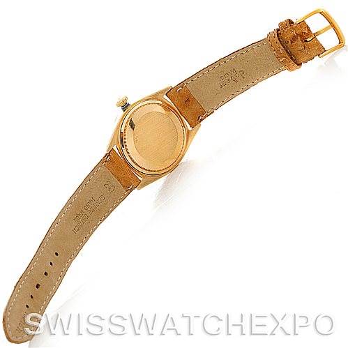 This image shows the back case and leather strap of a Rolex President 1807 Men's Yellow Gold Champagne Dial 1807 Men's Yellow Gold Champagne Dial model watch from a top-down angle.