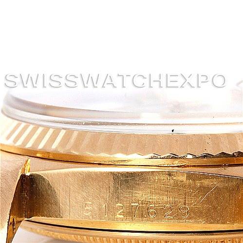 This image shows a close-up angle of the side of a Rolex President 1803 Men's Yellow Gold White Dial 1803 Men's Yellow Gold White Dial watch, including parts of the bezel, case, and engraved serial number.