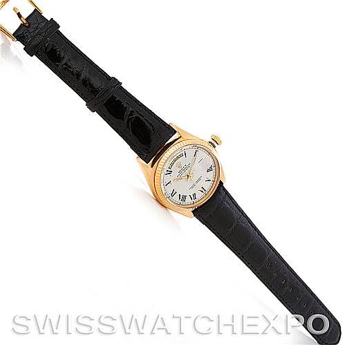 The image shows a Rolex President 1803 Men's Yellow Gold White Dial 1803 Men's Yellow Gold White Dial model watch from a top-down angle, displaying the dial, case, and black leather strap.