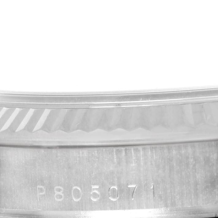 This image shows a close-up of the side of the case and the edge of the bezel of a Rolex President 118239 Men's White Gold Black Dial 118239 Men's White Gold Black Dial model watch.