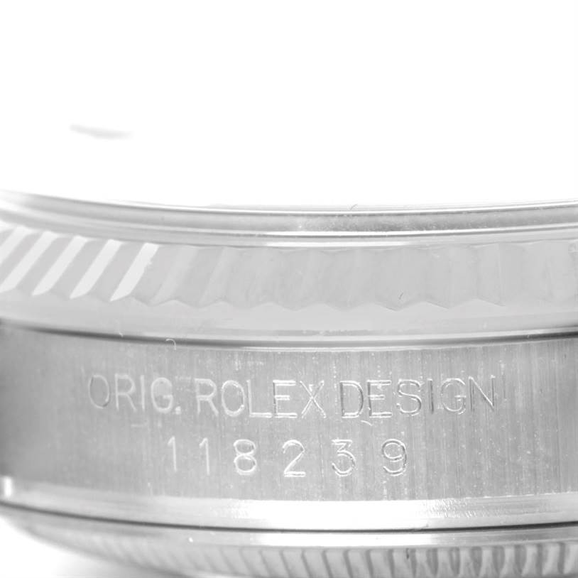 This image shows the engraved bezel and case sides of a Rolex President 118239 Men's White Gold Black Dial 118239 Men's White Gold Black Dial model watch from a close-up angle.