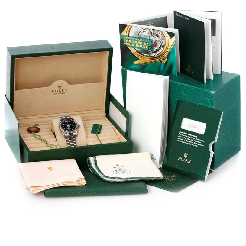 The image shows a Rolex President 118239 Men's White Gold Black Dial 118239 Men's White Gold Black Dial model watch at an angle inside its box, along with manuals, a cleaning cloth, and tags.