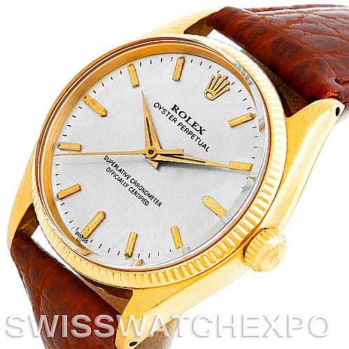 The image shows the face and bezel of a Rolex President 1005 Men's Yellow Gold Silver Dial 1005 Men's Yellow Gold Silver Dial model watch, angled slightly from the top right side, with a brown leather strap.