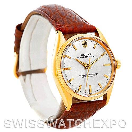 This image shows a Rolex President 1005 Men's Yellow Gold Silver Dial 1005 Men's Yellow Gold Silver Dial model watch at a slight angle, highlighting its gold case, brown leather strap, and white dial.