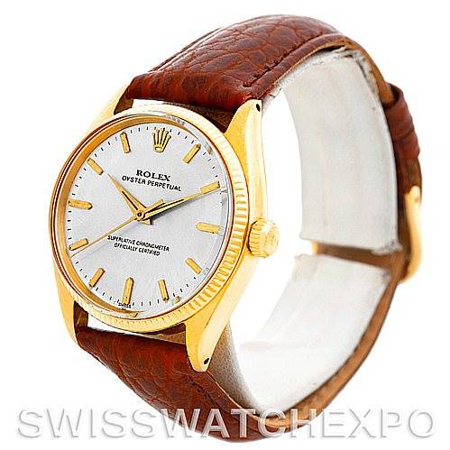 The Rolex President 1005 Men's Yellow Gold Silver Dial 1005 Men's Yellow Gold Silver Dial model watch is shown at an angle displaying its gold case, crown, dial, and leather strap.