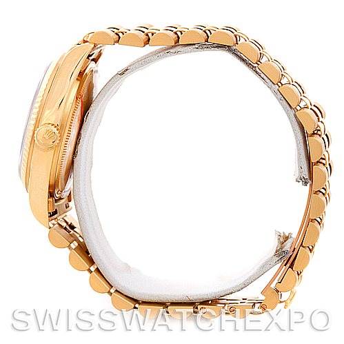 This image shows a President model Rolex watch from the side, highlighting the gold bracelet and the side profile of the case.