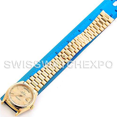 The image shows a Rolex President 18038 Men's Yellow Gold Champagne Dial 18038 Men's Yellow Gold Champagne Dial model watch laid flat next to a blue ruler, displaying the full length of the watch and bracelet.
