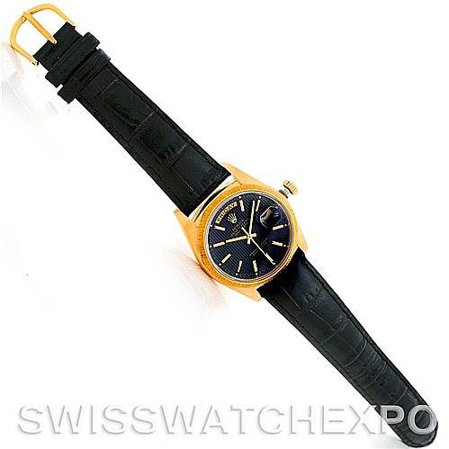 The image shows a top-down view of a Rolex President 18078 Men's Yellow Gold Black Dial 18078 Men's Yellow Gold Black Dial model watch with a black leather strap and a gold case.