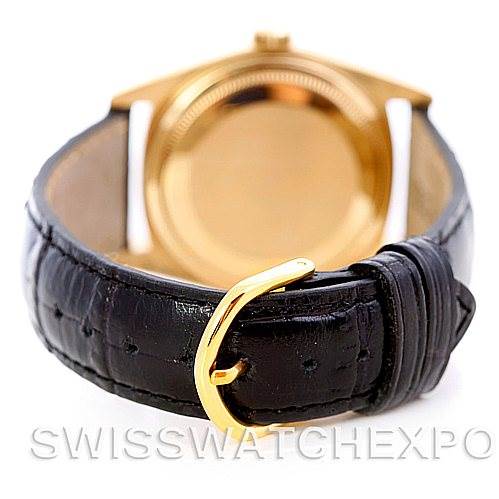The image shows the back view of a Rolex President 18078 Men's Yellow Gold Black Dial 18078 Men's Yellow Gold Black Dial model watch, highlighting its black leather strap and gold buckle.