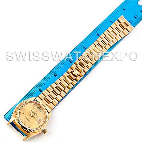 The image shows a top-down view of the Rolex President 18038 Men's Yellow Gold Champagne Dial 18038 Men's Yellow Gold Champagne Dial model watch with its case and whole bracelet laid against a blue ruler.