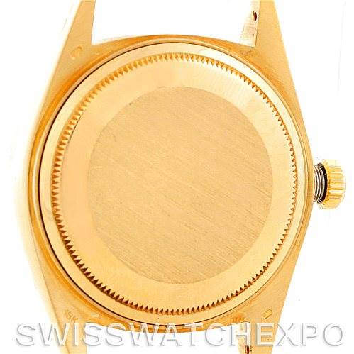 The image shows the back case and crown of a Rolex President 18038 Men's Yellow Gold Champagne Dial 18038 Men's Yellow Gold Champagne Dial model watch from a top-down angle.