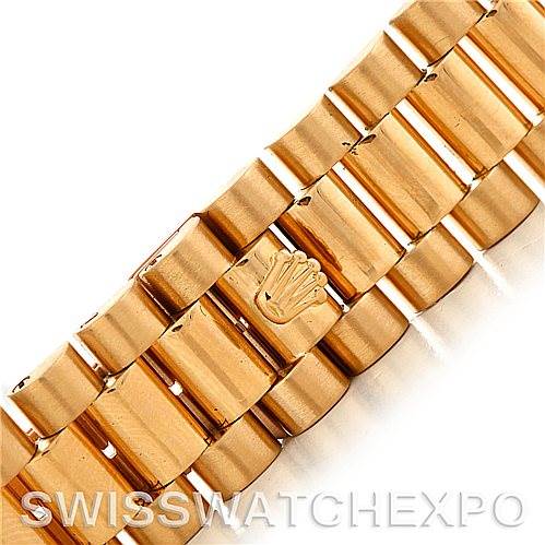 This image shows a close-up of the gold bracelet and clasp with the Rolex crown emblem on the President model by Rolex.