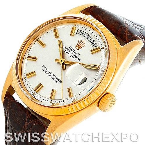 The image shows a close-up, angled view of a Rolex President 1803 Men's Yellow Gold Silver Dial 1803 Men's Yellow Gold Silver Dial model watch, highlighting its gold case, white dial, and leather strap.