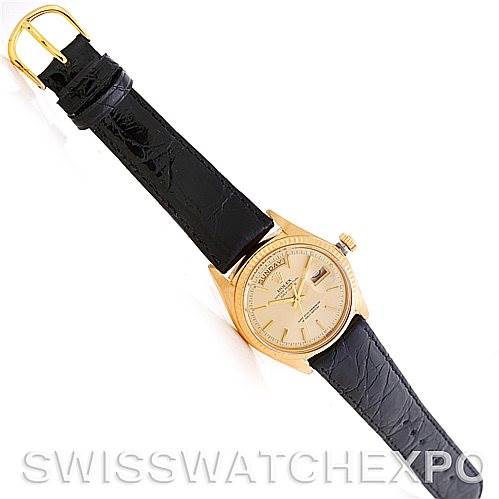 The image shows a top-down view of a Rolex President 1803 Men
s Yellow Gold Champagne Dial 1803 Men
s Yellow Gold Champagne Dial model watch with a black leather strap and gold case.